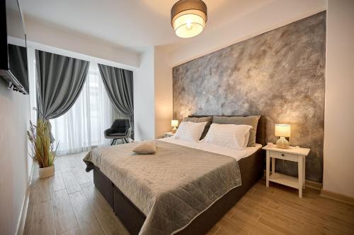 马马亚Infinity Breezes Apartment Beach Resort - parking的一间卧室设有一张大床和一个大墙