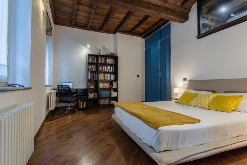都灵Elegante appartamento al Quadrilatero by Wonderful Italy的一间卧室设有一张大床和一个书架
