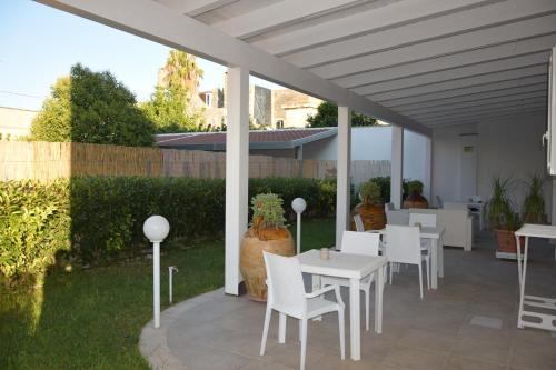 莱韦拉诺Il Matino的草坪上配有白色桌椅的庭院