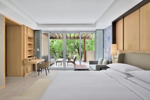 法里达巴德Courtyard by Marriott Aravali Resort的一间卧室设有一张床和一间客厅。