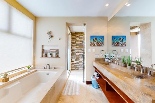 奥科塔尔Azul Paraiso 8B的一间带两个盥洗盆、浴缸和窗户的浴室