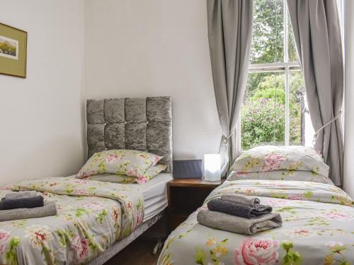 毕晓普奥克兰The Nook的一间卧室设有两张单人床和一个窗户。