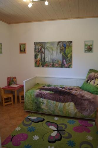 HornburgDas kleine Haus的卧室配有一张床,墙上挂有绘画作品