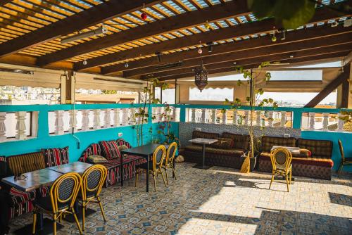 拿撒勒Daher Guest House Nazareth的餐厅拥有蓝色的墙壁和桌椅