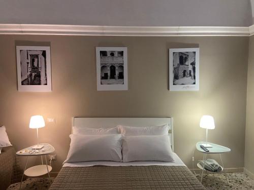 比通托B&B Porta Baresana的卧室配有一张墙上三幅照片的床