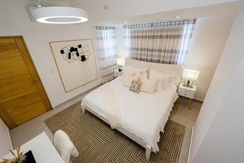 圣多明各Stunning view of the city.的一间卧室配有带白色床单和枕头的床。