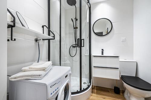 索波特Apartament Octopus Sopot Kamienny Potok的带淋浴和洗衣机的白色浴室