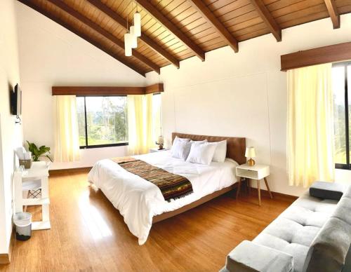塔巴贝拉Quito Airport Suites Hotel的一间卧室配有一张大床和一张沙发