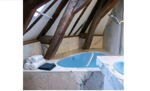 昂热Suite Toussaint - Calme & Authentique的阁楼上的浴室设有蓝色浴缸