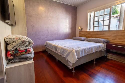 本图贡萨尔维斯Casa confortável e aconchegante的一间卧室配有一张床和一台电视