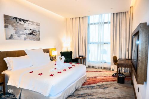 吉达Jasmine Garden Hotel的酒店客房的床铺上摆放着红色玫瑰花