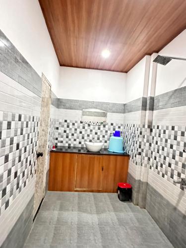 阿勒皮Noel's beach homestay的一间铺有瓷砖的客房内,浴室内配有水槽