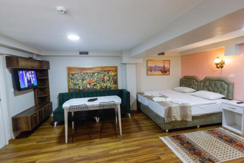 伊斯坦布尔Fidelya Boutique Hotel的酒店客房设有两张床和电视。
