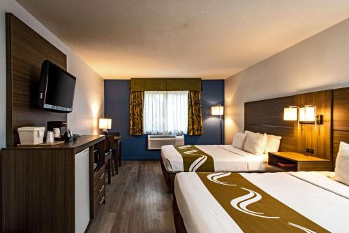 图莱里Quality Inn & Suites的酒店客房设有两张床和一台平面电视。