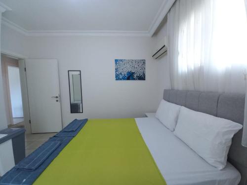 费特希耶Perfect Holiday Condo at Central Fethiye Best for Families的小房间,配有一张带绿毯的床