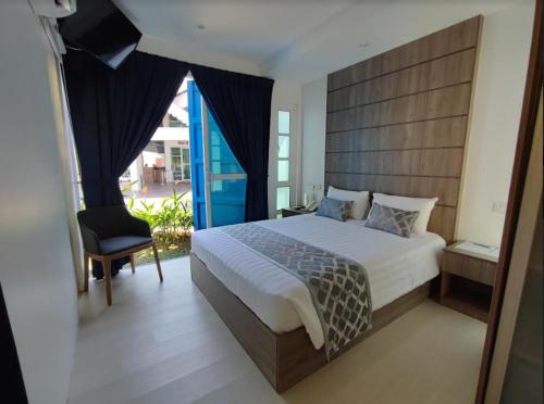 波德申Solesor Kampong Beach Resort的一间卧室配有一张大床和一把椅子