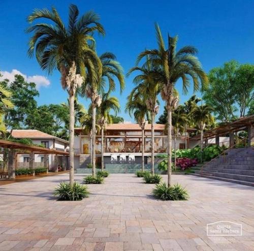 皮雷诺波利斯Resort Quinta Sta Bárbara的一座楼前种有棕榈树的庭院
