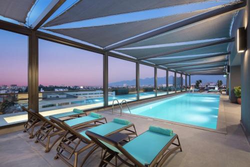安塔利亚Doubletree By Hilton Antalya City Centre的建筑物屋顶上的游泳池