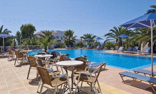 特尔桑纳斯特尔桑纳斯乡村公寓酒店的酒店庭院设有桌椅和游泳池。