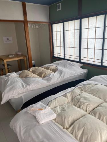 弘前市guest house goose - Vacation STAY 21037v的带窗户的客房内设有两张大床