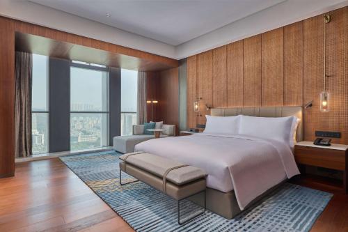 重庆重庆两江新区高科希尔顿酒店的一间卧室配有一张大床和一张沙发