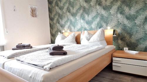 古梅尔斯巴赫Exklusives Ferienhaus "Agger-Blick" mit riesiger Seeblick-Terrasse, Sauna, E-Kamin & Kajak的一间卧室配有一张大床和毛巾
