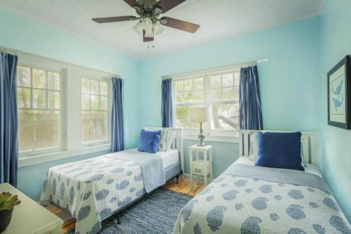 西棕榈滩Casa Paradiso 3bd 2ba Private Pool and Cabana的配有两张床铺的蓝色墙壁和窗户