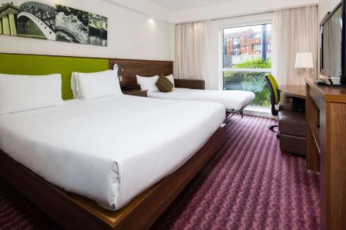 伯明翰希尔顿伯明翰珠宝区汉普顿酒店的酒店客房设有两张床和电视。