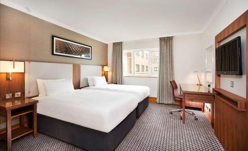 考文垂DoubleTree by Hilton Coventry的酒店客房设有一张白色大床和一张书桌