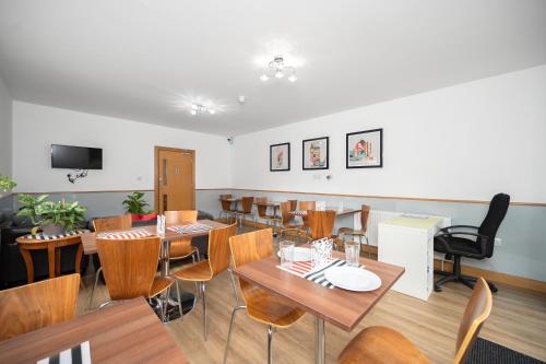 萨顿Flexistay Aparthotel Sutton的用餐室配有木桌和椅子