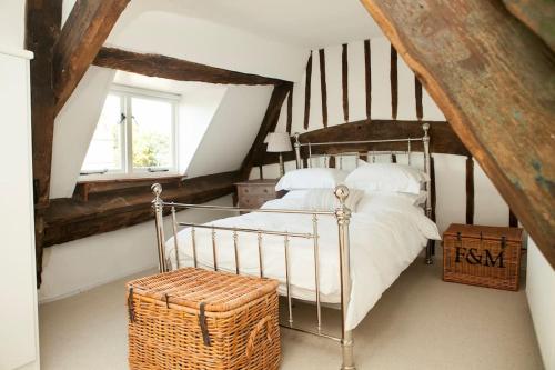 奇平诺顿Spring Cottage的阁楼上的卧室配有金属床