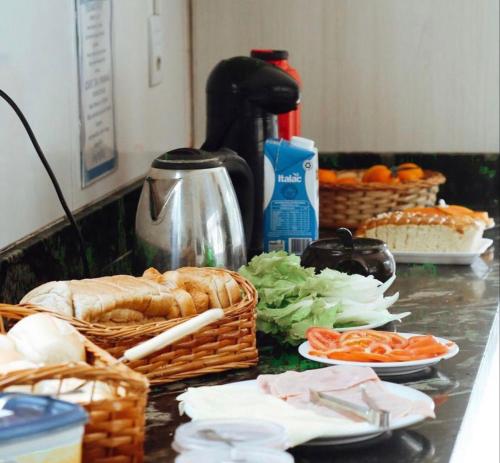 弗洛里亚诺波利斯Sea Wolf Hostel - Lagoa da Conceição的厨房柜台,备有面包和蔬菜篮子