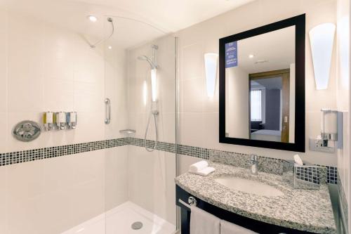 克卢日-纳波卡汉普顿克卢日纳波卡希尔顿酒店的一间带水槽、淋浴和镜子的浴室