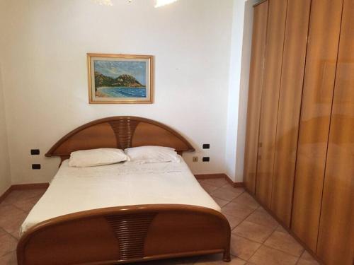 圣维托Domu Santu Idu的一间卧室配有一张带木制床头板的床