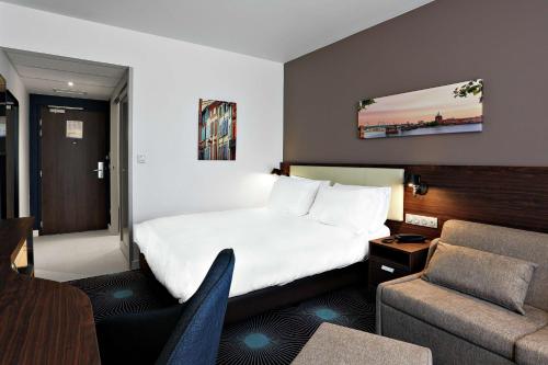 布拉尼亚克Hampton By Hilton Toulouse Airport的酒店客房,配有床和沙发