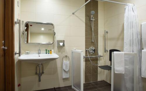 乌法乌法滨江希尔顿花园酒店的浴室配有盥洗盆和带镜子的淋浴
