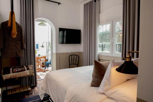 利马Fausto的一间卧室设有一张床、一台电视和一个窗口。