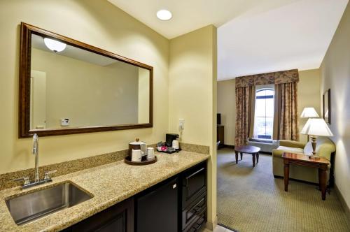查尔斯顿北查尔斯顿-大学大道希尔顿恒庭套房酒店的酒店客房设有水槽和镜子