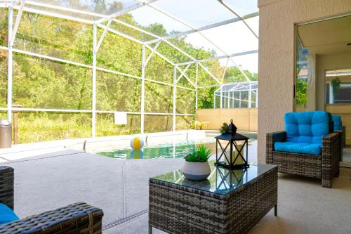 基西米Private house Kissimmee/Orlando的客厅,带玻璃房子和游泳池