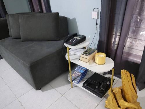 圣巴勃罗Home in San Pablo city, Laguna的一间房间,配有一张床和一张桌子上的电话