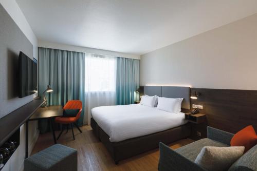 土伦土伦市中心假日旅馆的酒店客房,配有一张床、一张桌子和椅子