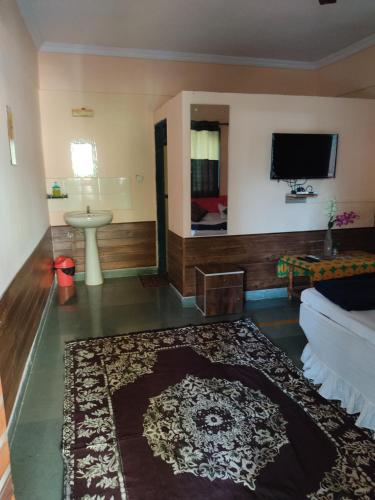 KīhīmVisava Cottages Kihim Beach的客厅配有沙发和墙上的电视