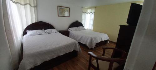 派帕villa concha的酒店客房,配有两张床和椅子