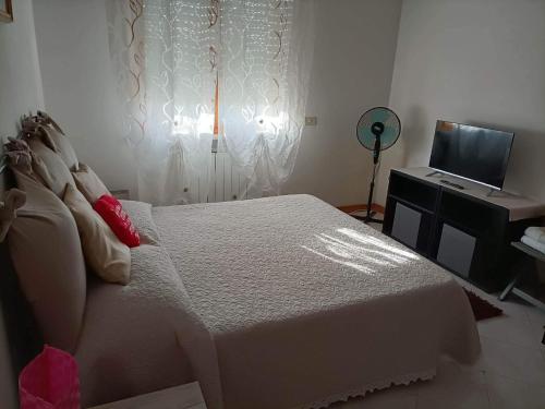 钦克亚勒Wanderful room的卧室配有白色的床和电视。
