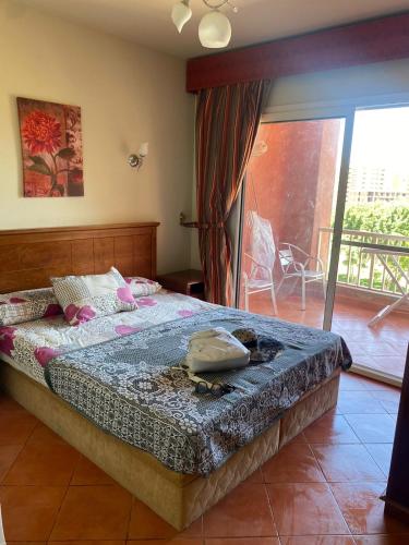 阿莱曼Gulf Porto Marina Call First的一间卧室设有一张床和一个阳台