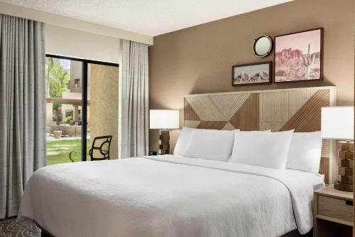 坦培Embassy Suites by Hilton Phoenix Tempe的一间卧室设有一张大床和一个大窗户