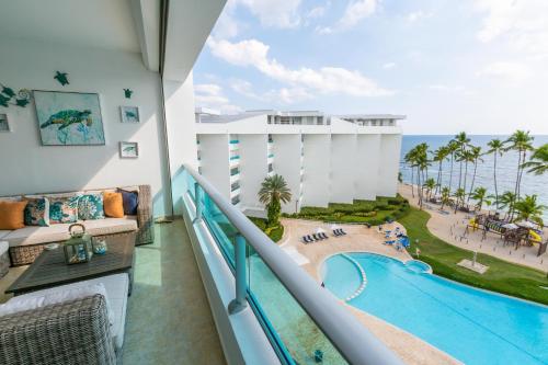 璜多里奥Marbella Juan Dolio Beachfront的从度假村的阳台上可欣赏到游泳池的景色