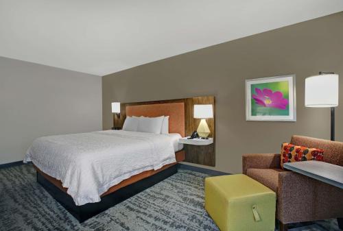 索尔兹伯里索尔兹伯里汉普顿酒店的配有一张床和一把椅子的酒店客房