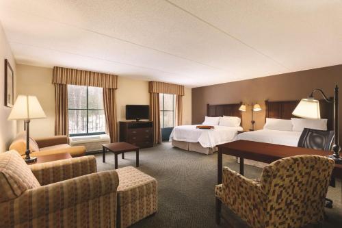 乔治湖乔治湖汉普顿套房酒店的酒店客房,设有两张床和一张沙发