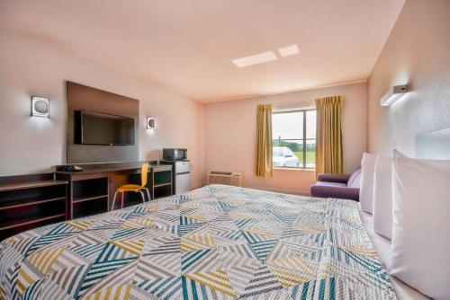 斯普林菲尔德斯普林菲尔德OH6号汽车旅馆的酒店客房设有一张大床和一张书桌。